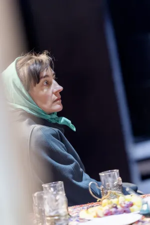 Schnappschuss von Constanze Becker im Profil. Sie trägt ein grünes Kopftuch. 